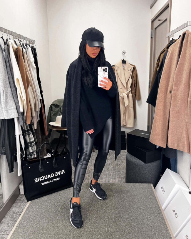 fashion blogger mia mia mine wearing a black sweater from the nsale 2022